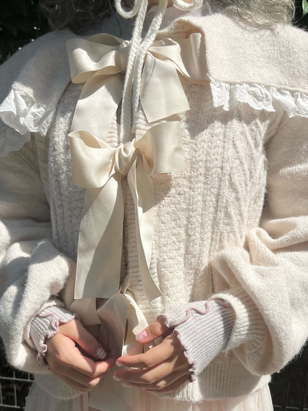 ホワイト系のカーディガン/ボレロ、グレー系のニット/セーター、ピンク系のワンピースを着用したレディースの秋コーディネートの4枚目の写真