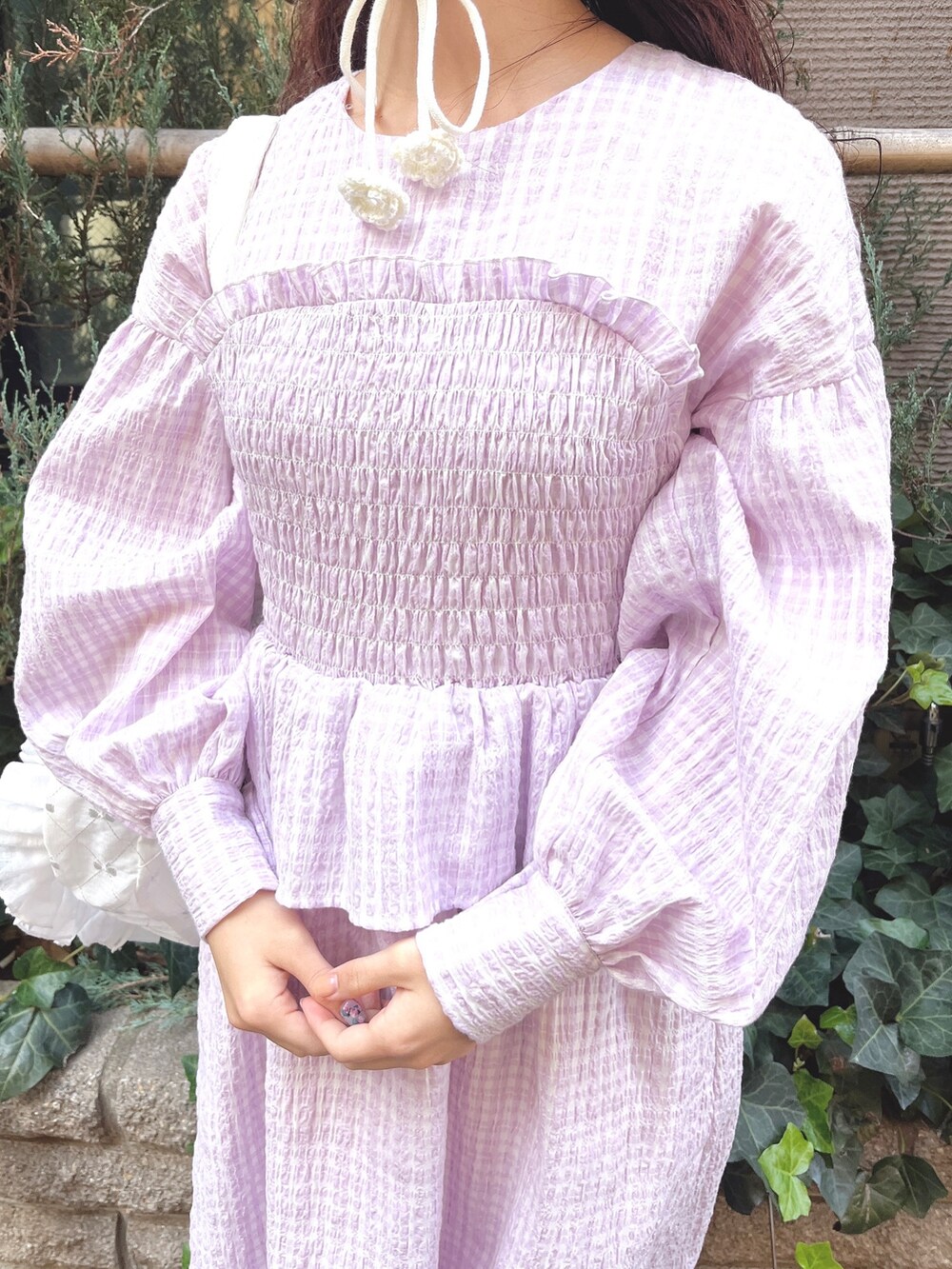 パープル系のワンピース、ホワイト系のトートバッグ、ホワイト系のバレエシューズを着用したレディースの冬コーディネートの7枚目の写真