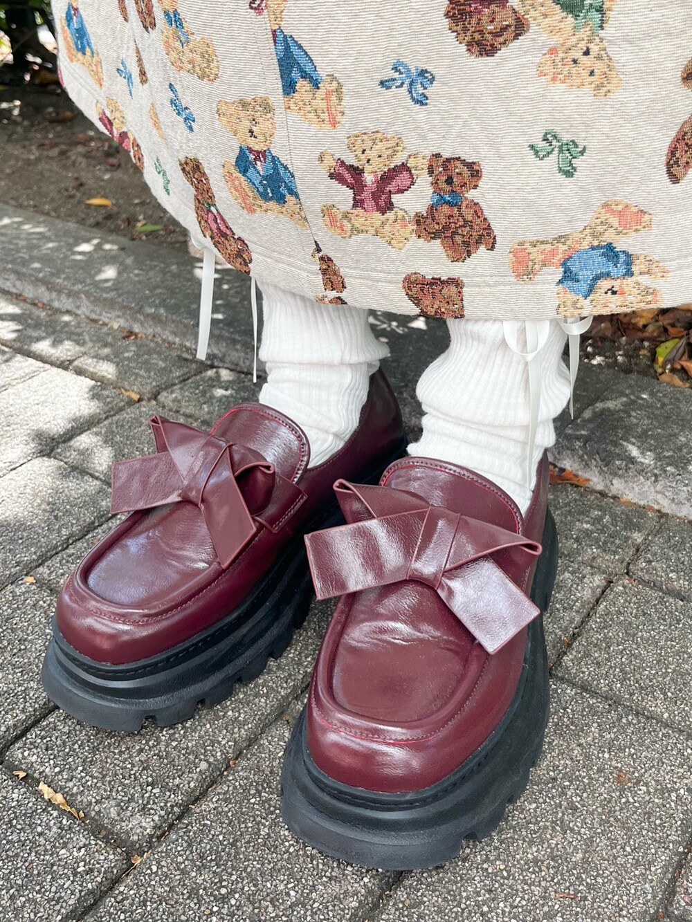 ホワイト系のシャツ/ブラウス、ホワイト系のジャンパースカート、グレー系のショルダーバッグを着用したレディースの秋コーディネートの10枚目の写真