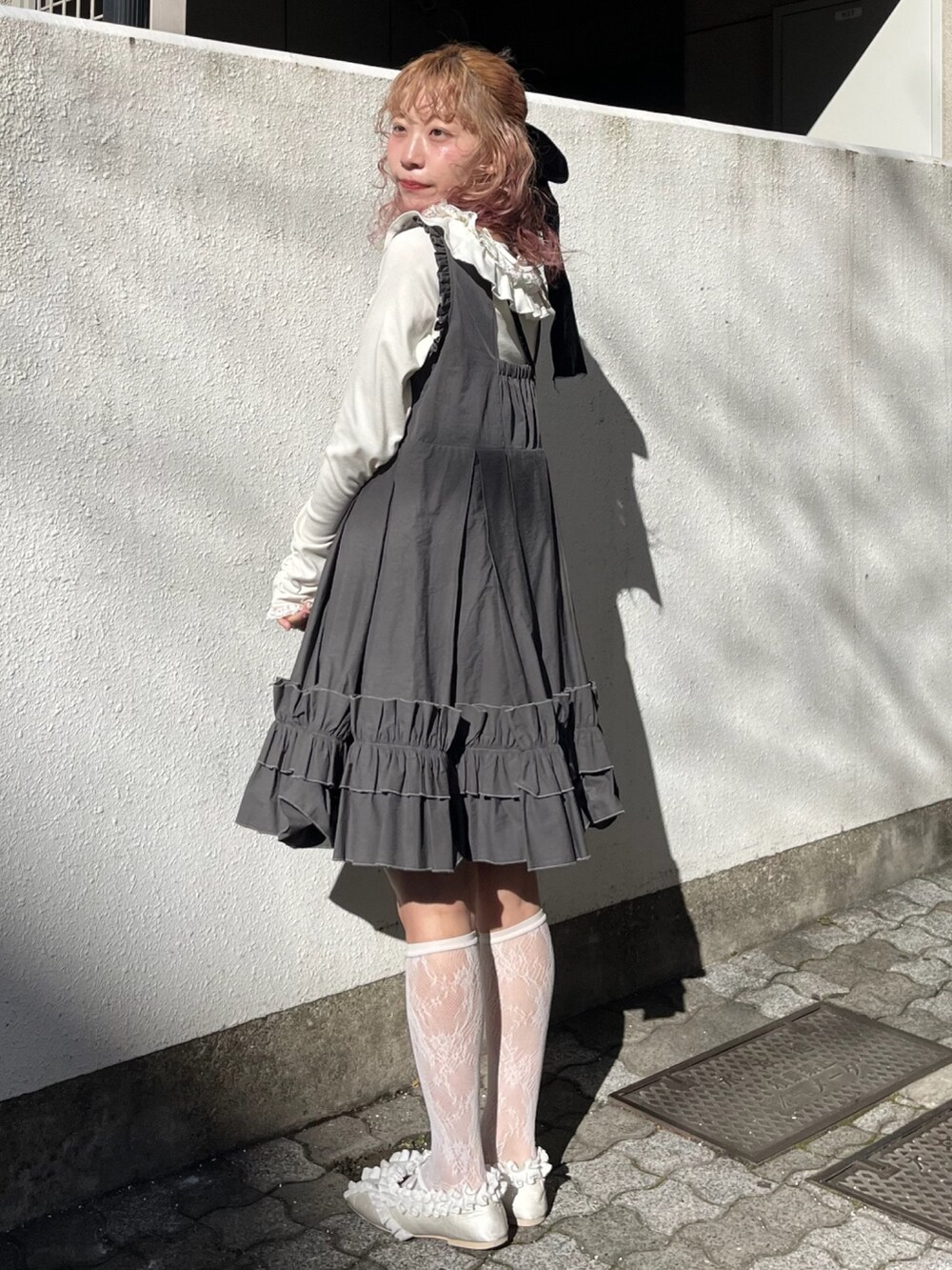 ホワイト系のTシャツ/カットソー、ブラック系のショルダーバッグ、グレー系のワンピースを着用したレディースの冬コーディネートの3枚目の写真