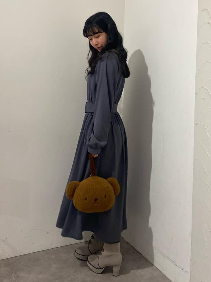 ベージュ系のブーツ、ブラウン系のハンドバッグ、ブルー系のワンピースを着用したレディースの秋コーディネートの3枚目の写真