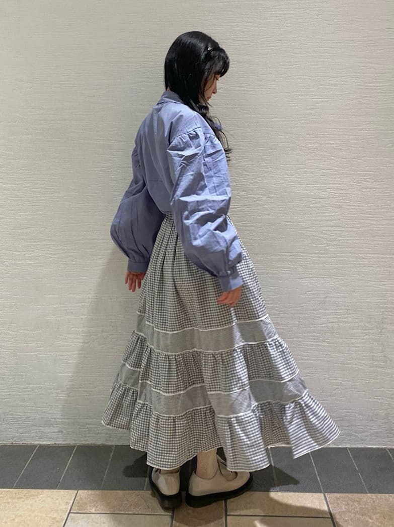 ホワイト系のパンプス、ブルー系のシャツ/ブラウス、グレー系のスカートを着用したレディースの冬コーディネートの3枚目の写真