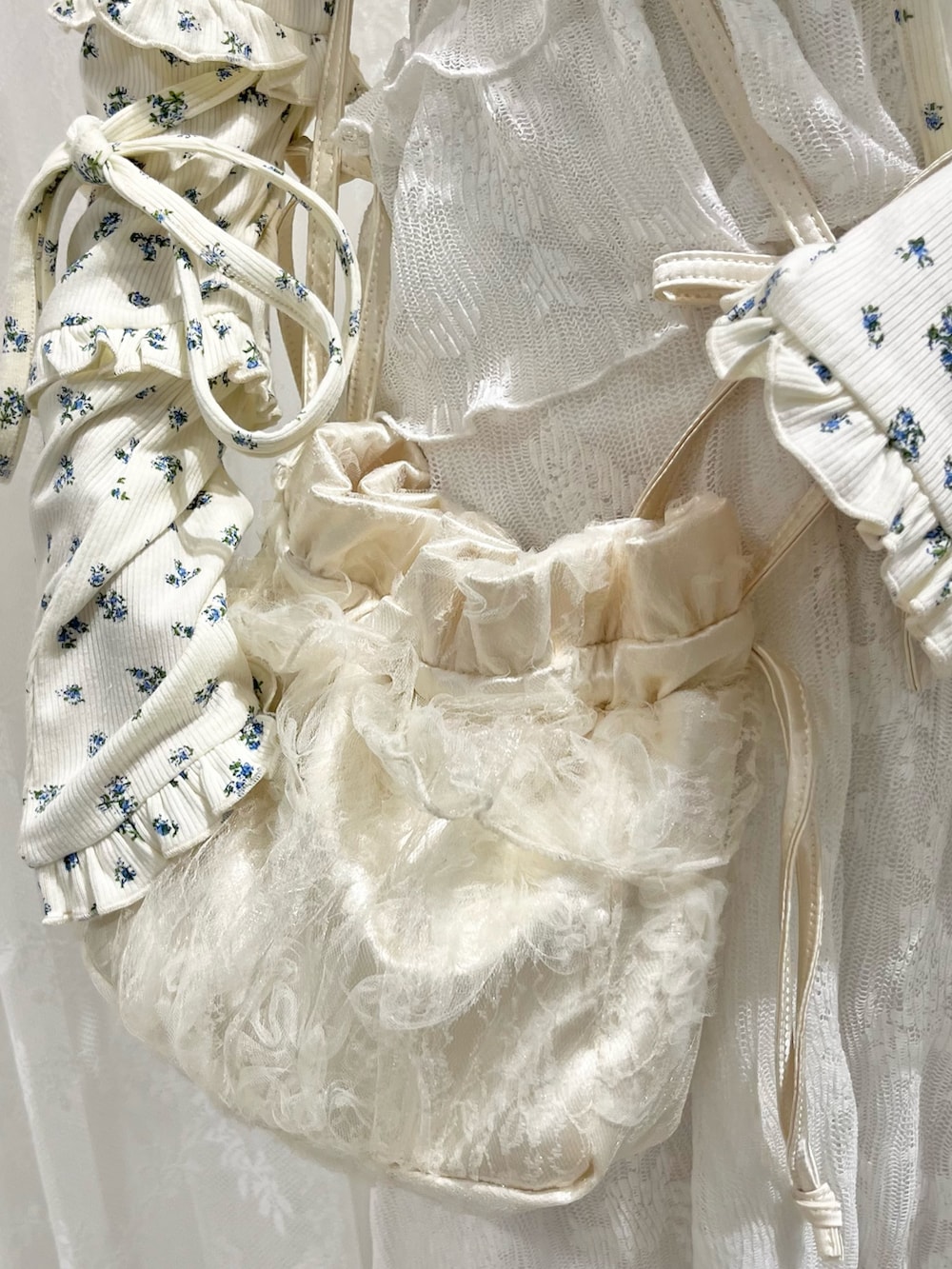 ホワイト系のカーディガン/ボレロ、ホワイト系のワンピース、ホワイト系のショルダーバッグを着用したレディースの夏コーディネートの9枚目の写真