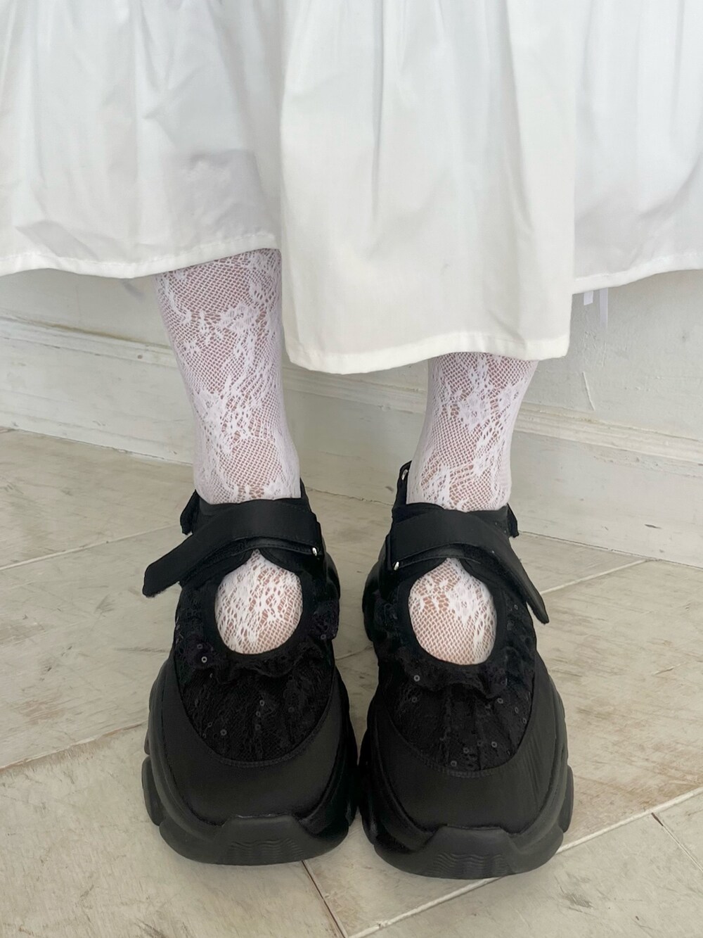 ホワイト系のワンピース、ブラック系のカーディガン/ボレロ、ホワイト系のショルダーバッグを着用したレディースの秋コーディネートの8枚目の写真