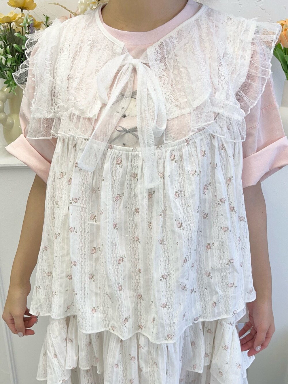 ピンク系のワンピース、ピンク系のTシャツ/カットソー、ベージュ系のスニーカーを着用したレディースの冬コーディネートの6枚目の写真