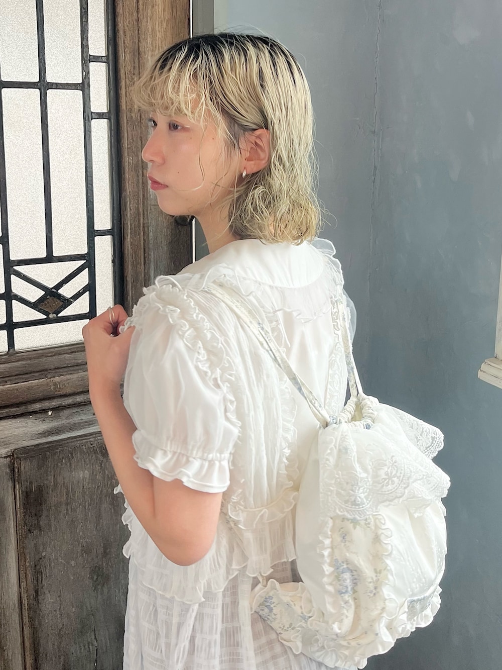 ホワイト系のワンピース、ブルー系のバックパック/リュック、ホワイト系のシャツ/ブラウスを着用したレディースの春コーディネートの7枚目の写真