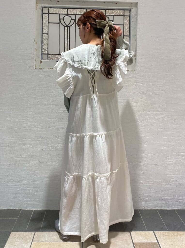 グリーン系のシャツ/ブラウス、ブルー系のパンプス、ホワイト系のワンピースを着用したレディースの冬コーディネートの3枚目の写真