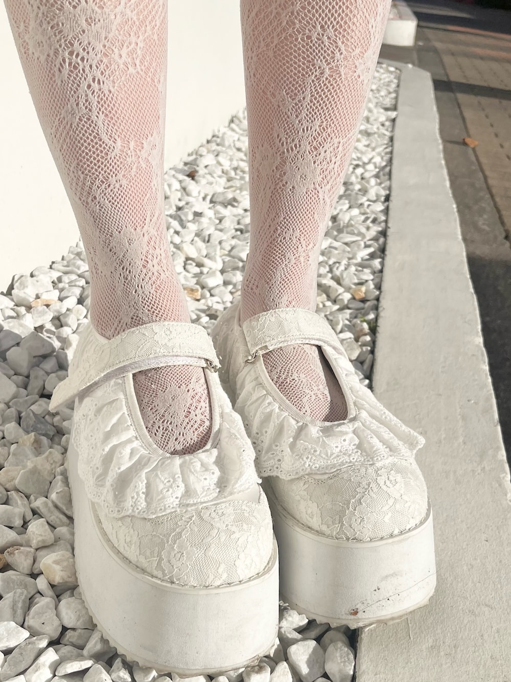 ホワイト系のワンピース、ピンク系のショルダーバッグ、ホワイト系のスニーカーを着用したレディースの冬コーディネートの10枚目の写真