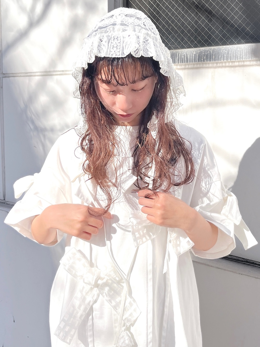 ホワイト系のスカート、ホワイト系のTシャツ/カットソー、シルバー系のバレエシューズを着用したレディースの冬コーディネートの6枚目の写真