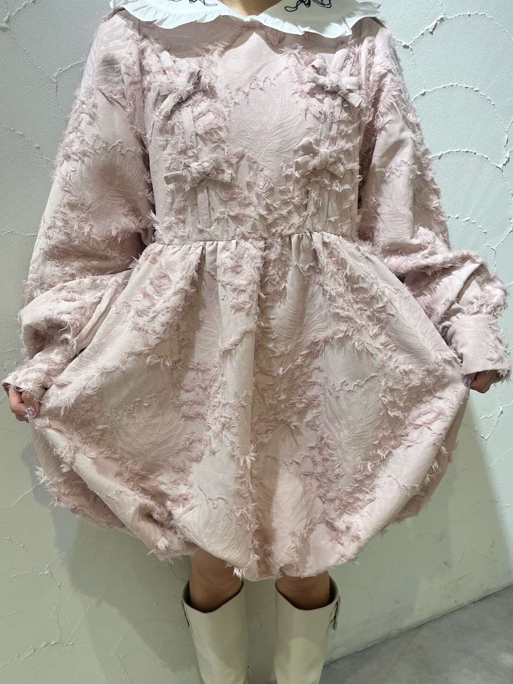 ピンク系のワンピース、ホワイト系のシャツ/ブラウス、ホワイト系のブーツを着用したレディースの秋コーディネートの9枚目の写真