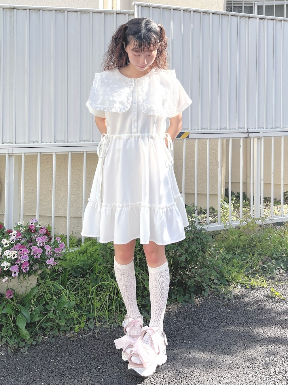 ホワイト系のワンピース、ピンク系のサンダルを着用したレディースの春コーディネートの2枚目の写真