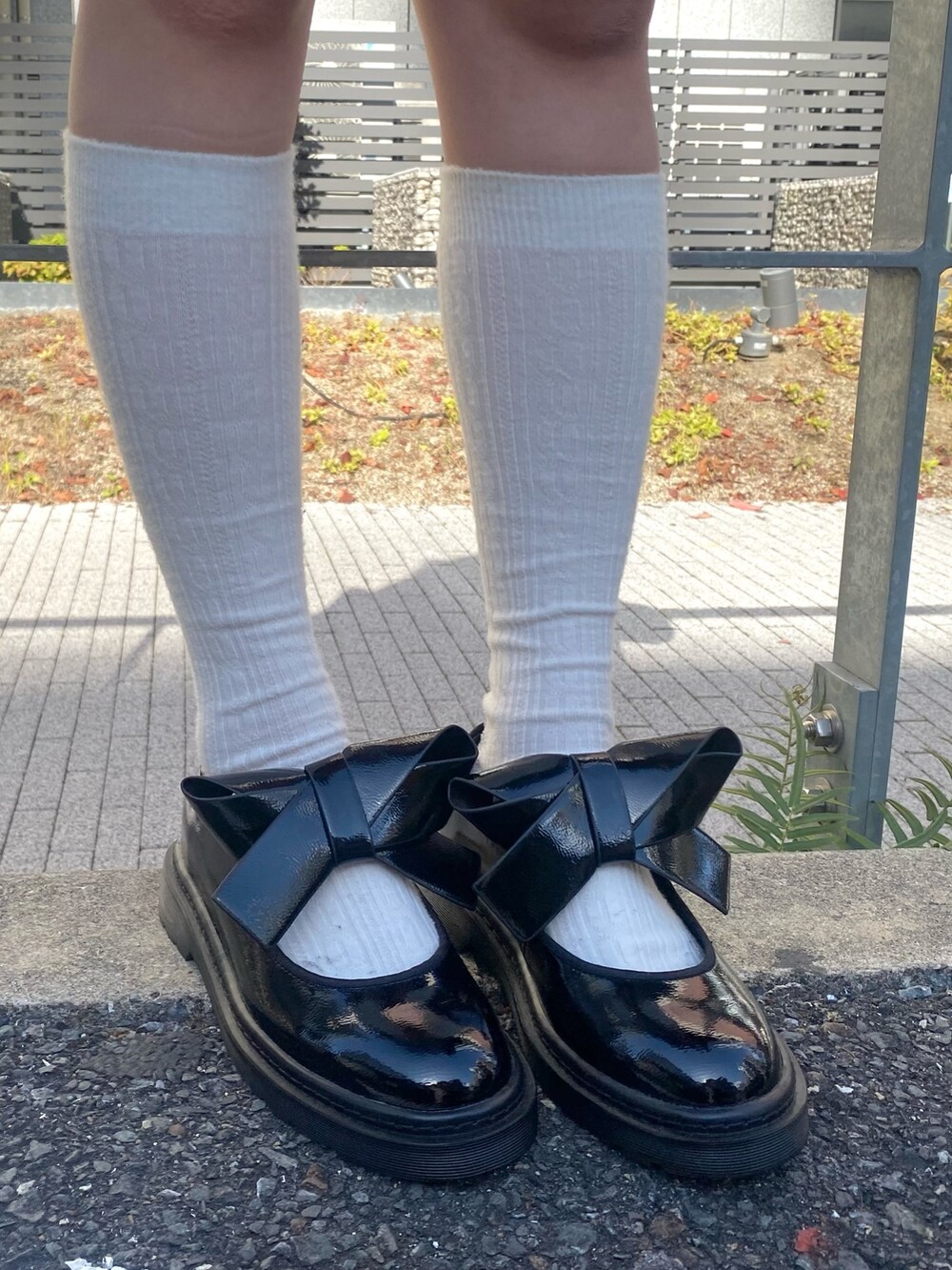 ブラック系のその他アウター、ホワイト系のシャツ/ブラウス、レッド系のスカートを着用したレディースの秋コーディネートの6枚目の写真