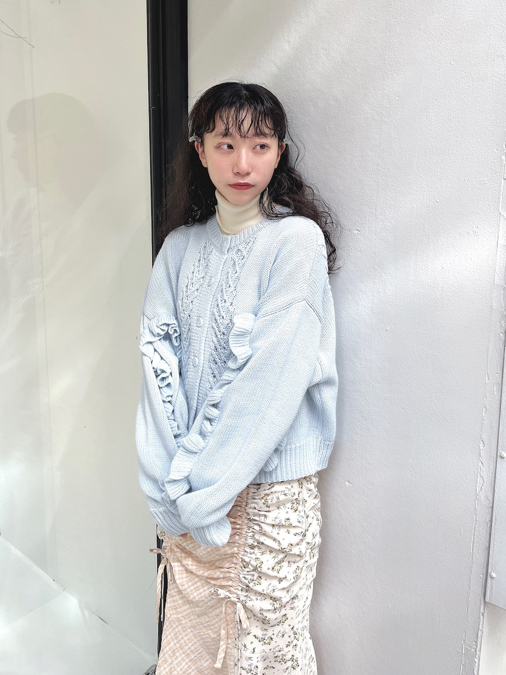 ホワイト系のニット/セーター、ブルー系のカーディガン/ボレロ、ホワイト系のスカートを着用したレディースの秋コーディネートの4枚目の写真
