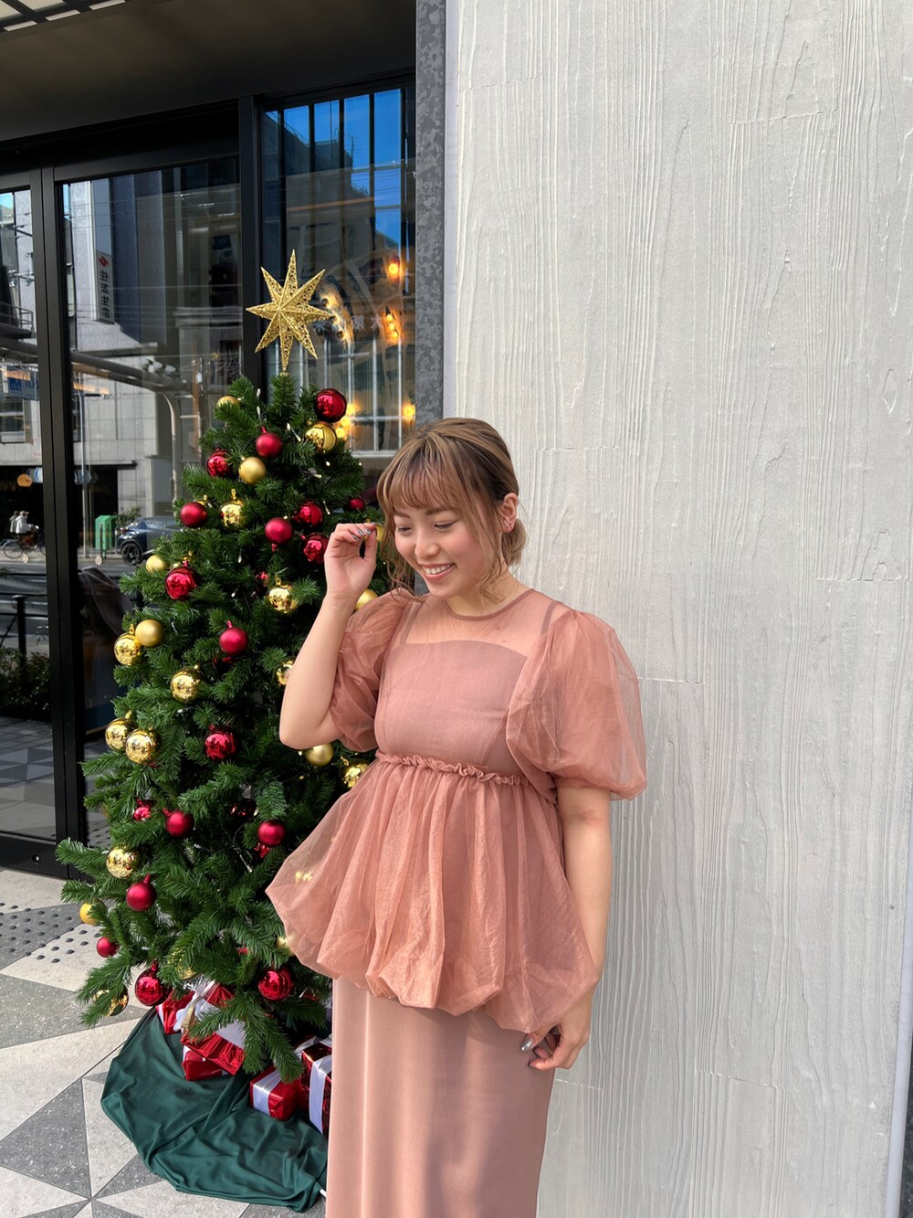 オレンジ系のドレスを着用したレディースの冬コーディネートの3枚目の写真