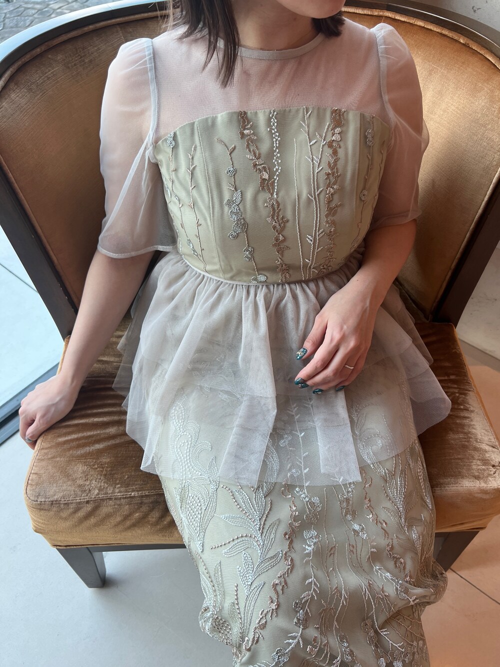 イエロー系のドレス、ベージュ系のシューズを着用したレディースの春コーディネートの2枚目の写真