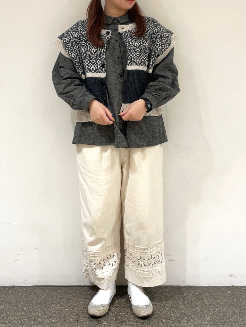 グレー系のシャツ/ブラウス、グレー系のベスト、ホワイト系のその他パンツを着用したレディースの冬コーディネートの2枚目の写真