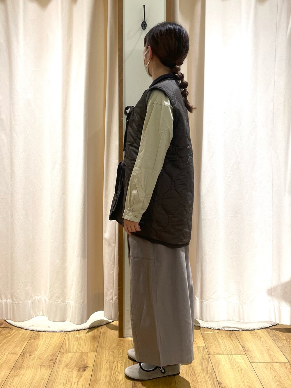 ベージュ系のシャツ/ブラウス、ブルー系のベスト、グレー系のその他パンツを着用したレディースの秋コーディネートの2枚目の写真