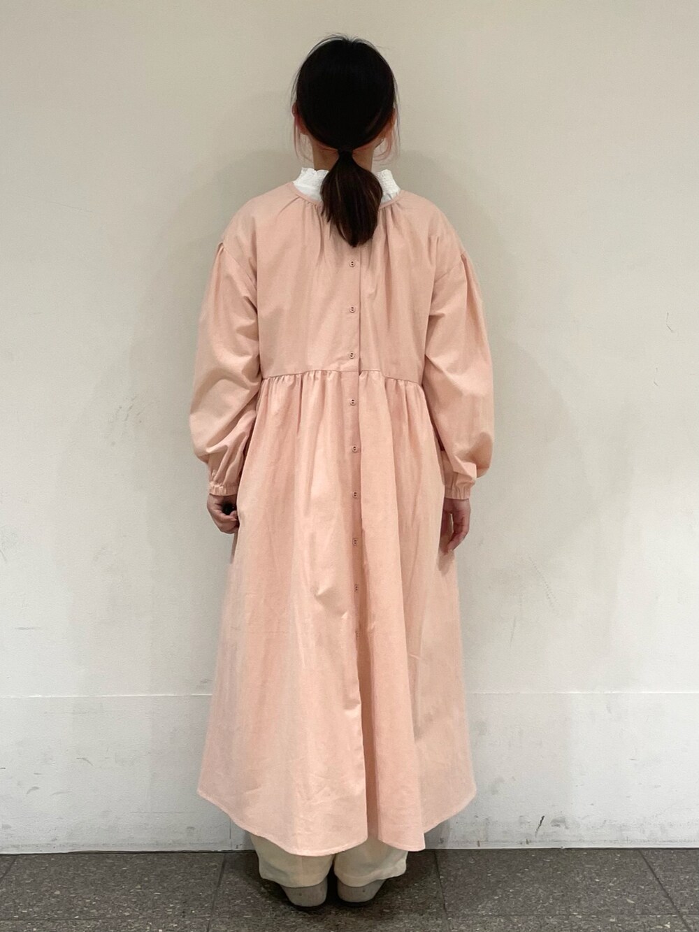 ベージュ系のドレスシューズ、ピンク系のワンピース、ホワイト系のその他パンツを着用したレディースの冬コーディネートの4枚目の写真