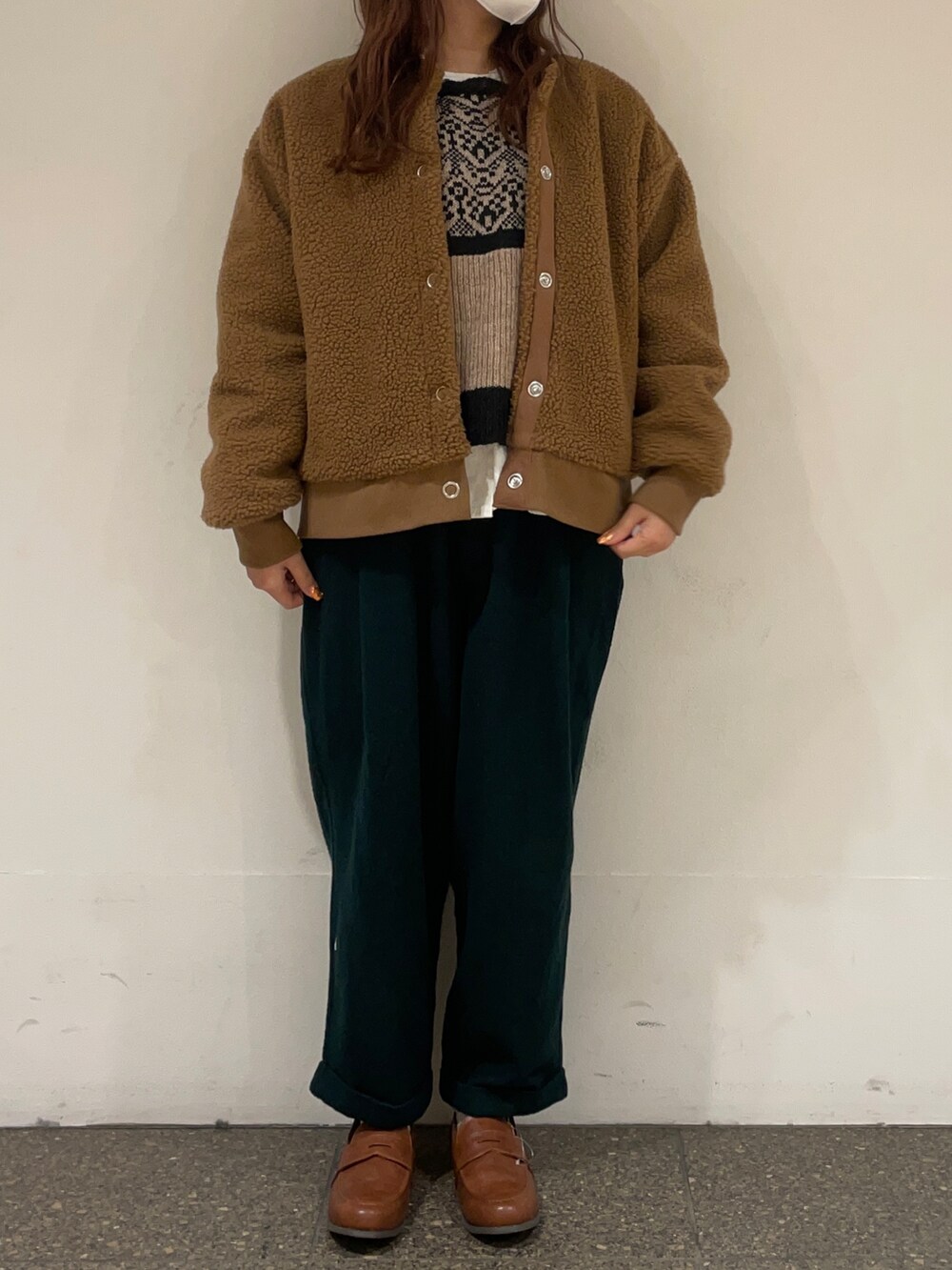 イエロー系のブルゾン、ホワイト系のシャツ/ブラウス、ブラウン系のベストを着用したレディースの冬コーディネートの2枚目の写真