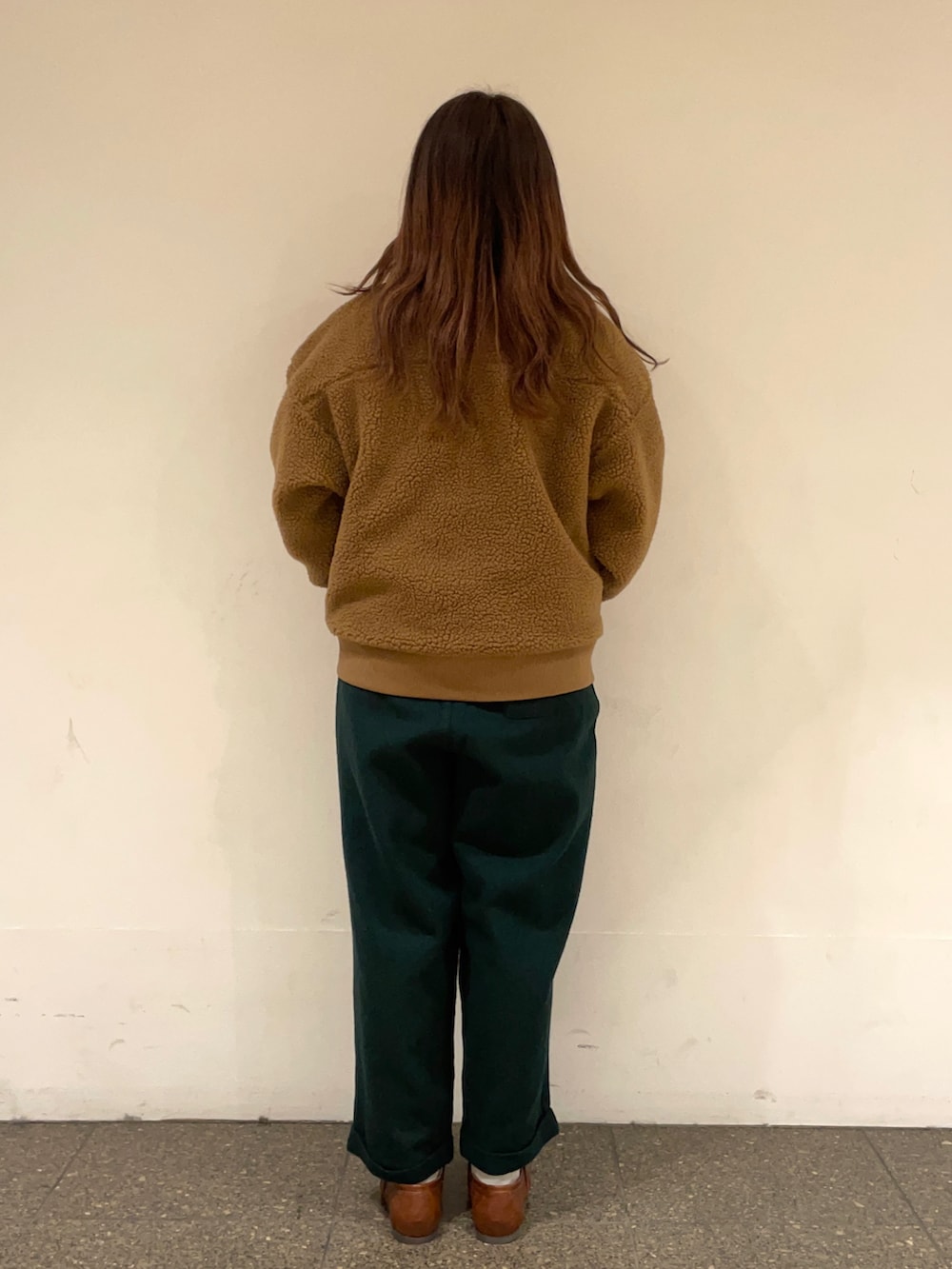 イエロー系のブルゾン、ホワイト系のシャツ/ブラウス、ブラウン系のベストを着用したレディースの冬コーディネートの4枚目の写真