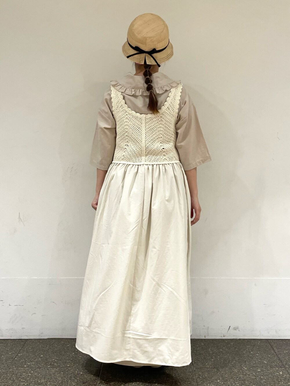 ベージュ系のワンピース、ホワイト系のワンピース、ブラック系のハットを着用したレディースの秋コーディネートの4枚目の写真