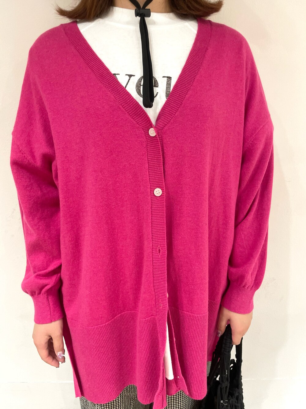 ホワイト系のTシャツ/カットソー、ピンク系のカーディガン/ボレロ、ブラック系のハンドバッグを着用したレディースの春コーディネートの4枚目の写真