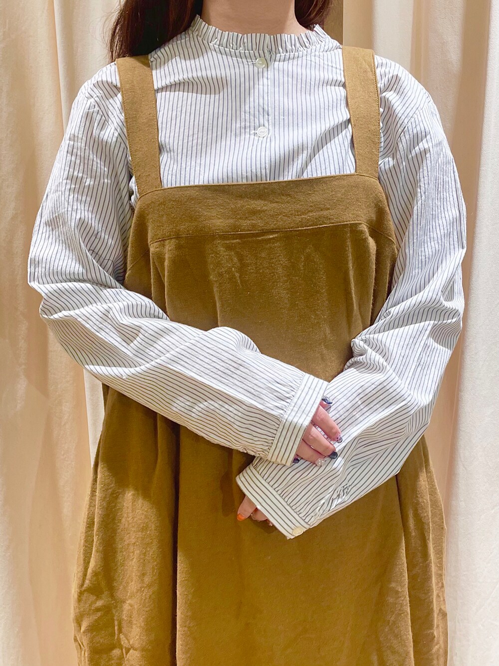 ホワイト系のシャツ/ブラウス、イエロー系のジャンパースカート、ブラウン系のサンダルを着用したレディースの秋コーディネートの5枚目の写真