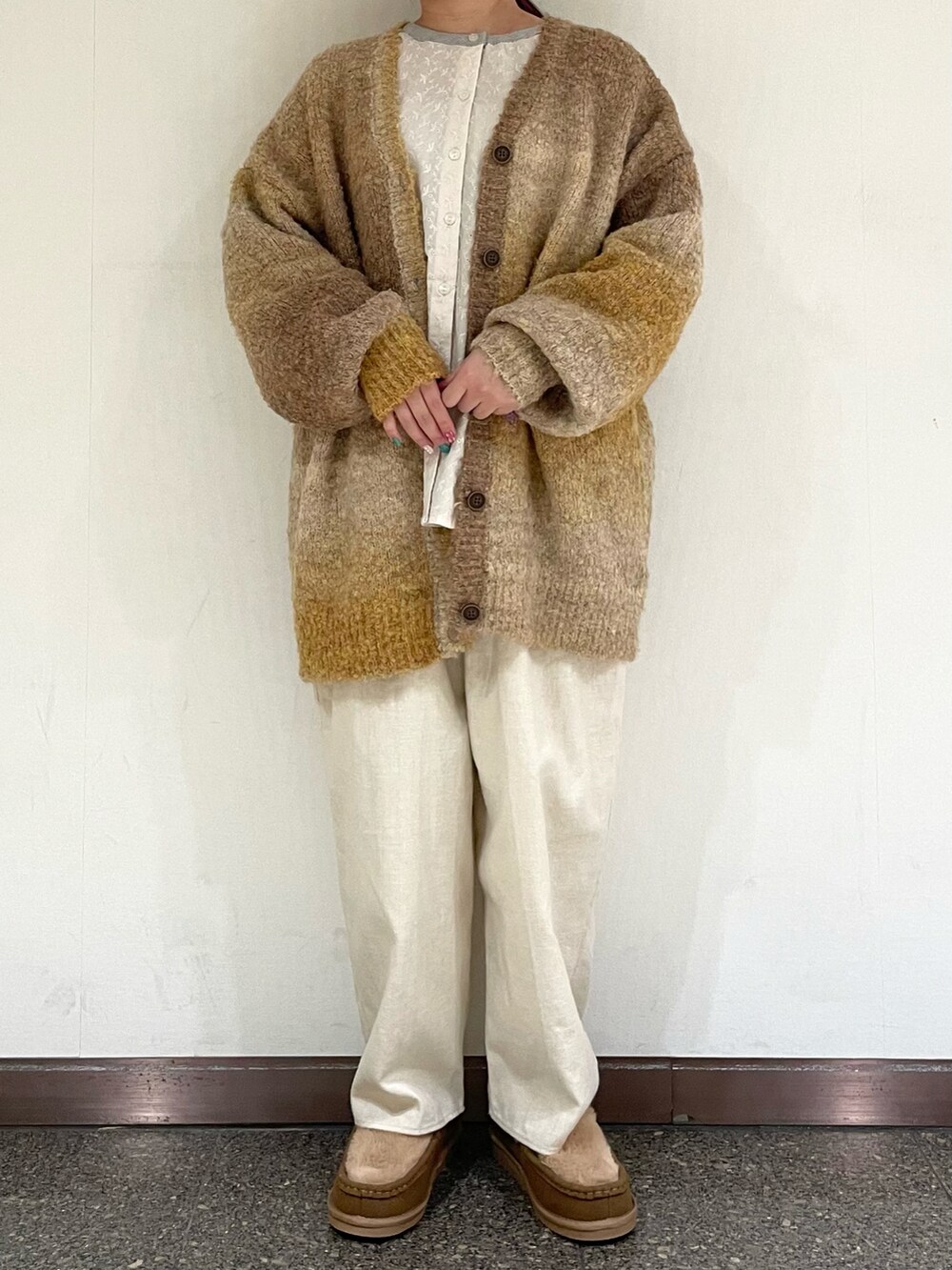 イエロー系のその他シューズ、ホワイト系のハットを着用したレディースの冬コーディネートの2枚目の写真