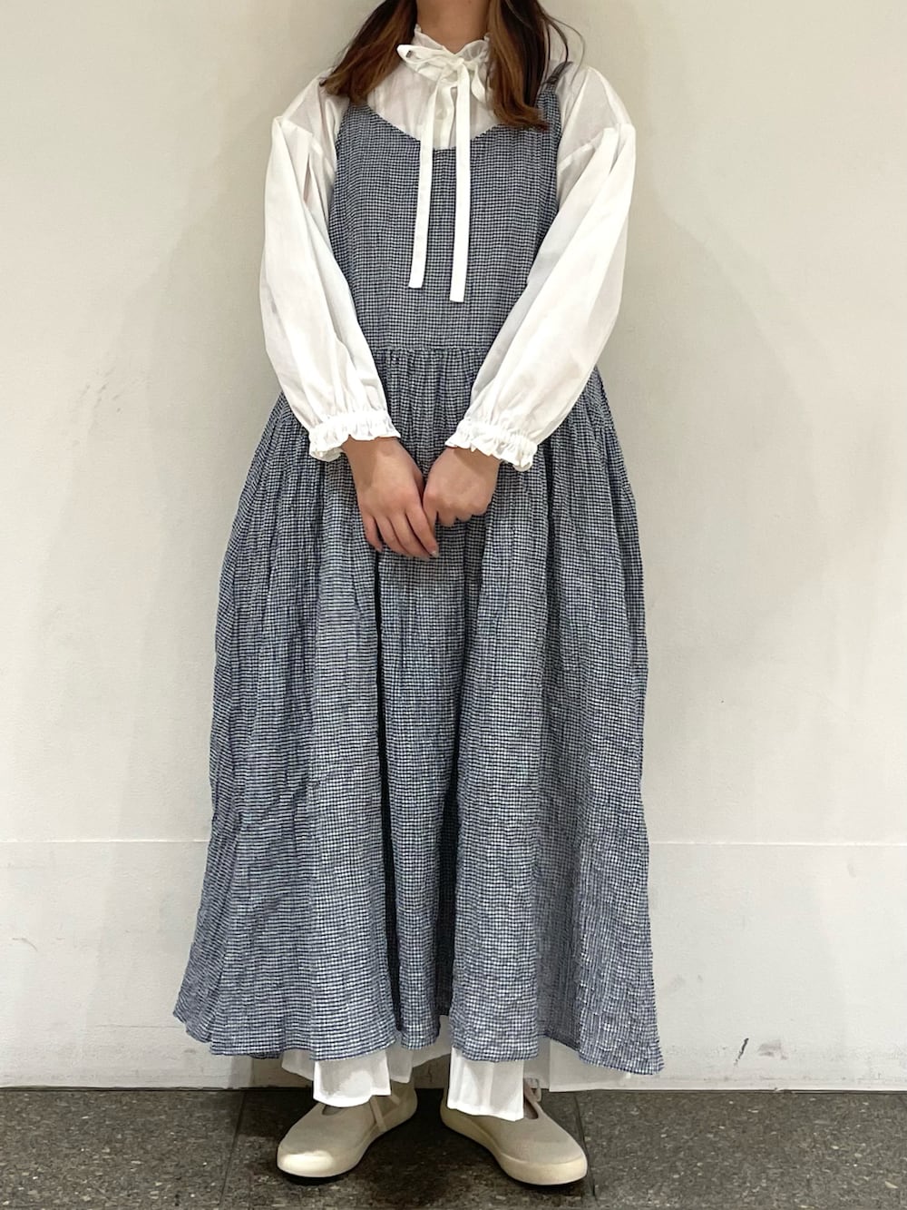 ホワイト系のスニーカー、ホワイト系のシャツ/ブラウス、ブルー系のワンピースを着用したレディースの春コーディネートの2枚目の写真