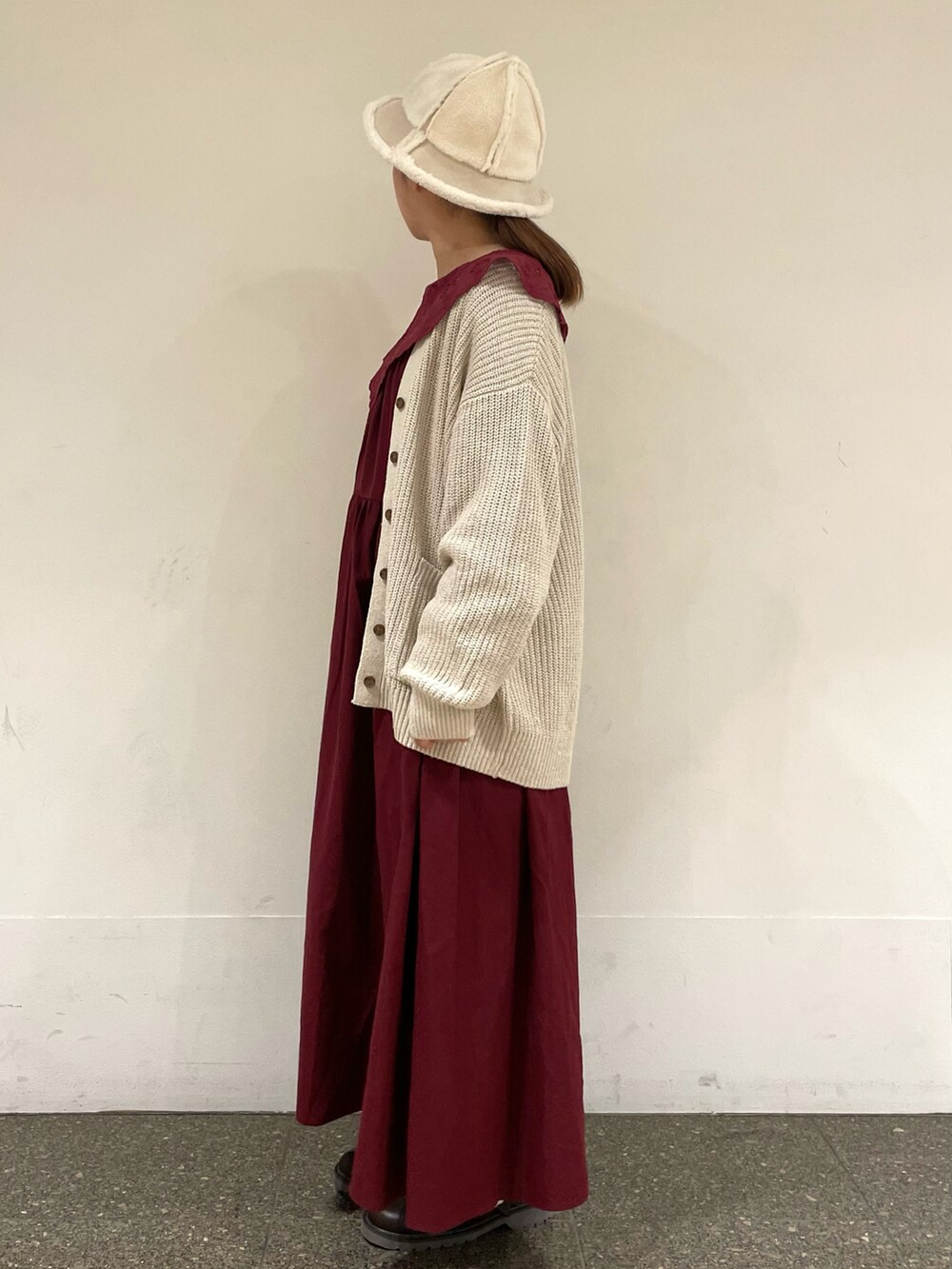 レッド系のワンピース、ホワイト系のその他パンツ、ブラウン系のサンダルを着用したレディースの秋コーディネートの3枚目の写真