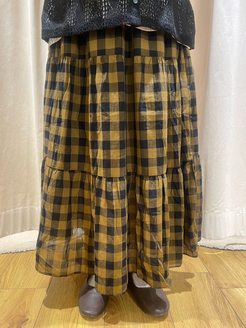 ホワイト系のTシャツ/カットソー、ブラック系のカーディガン/ボレロ、イエロー系のスカートを着用したレディースの夏コーディネートの5枚目の写真