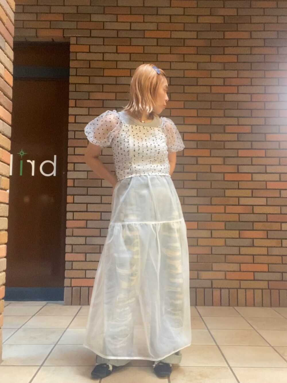 ホワイト系のトップス、ホワイト系のスカート、ブラック系のバレエシューズを着用したレディースの夏コーディネートの3枚目の写真