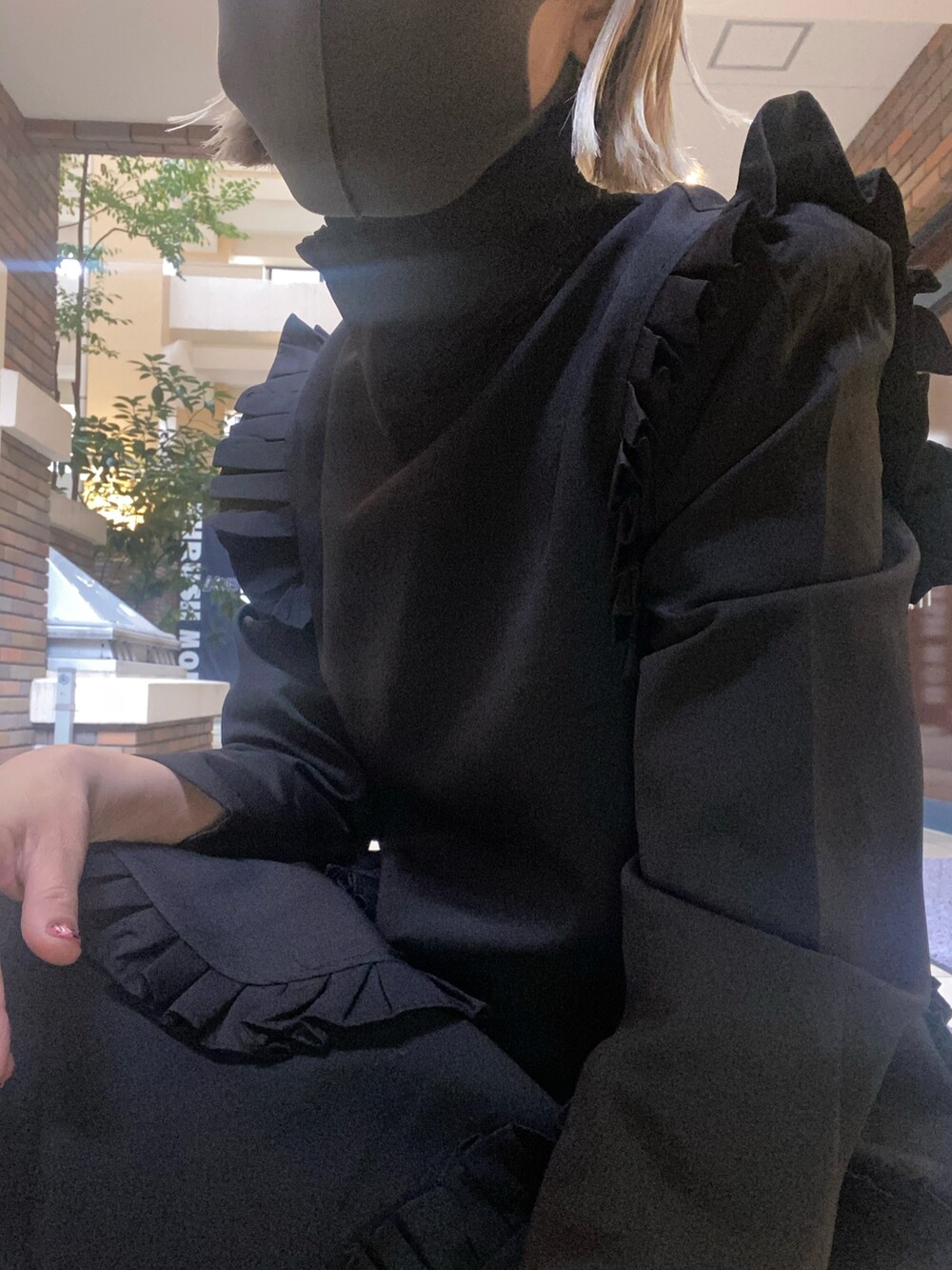 シルバー系のパンプス、ブラック系のワンピースを着用したレディースの秋コーディネートの3枚目の写真