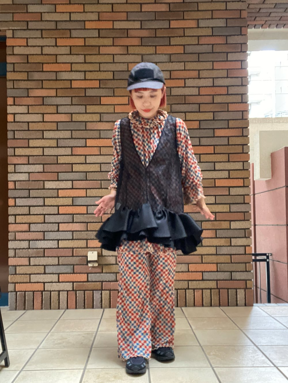 ブラック系のチュニックを着用したレディースの秋コーディネートの2枚目の写真