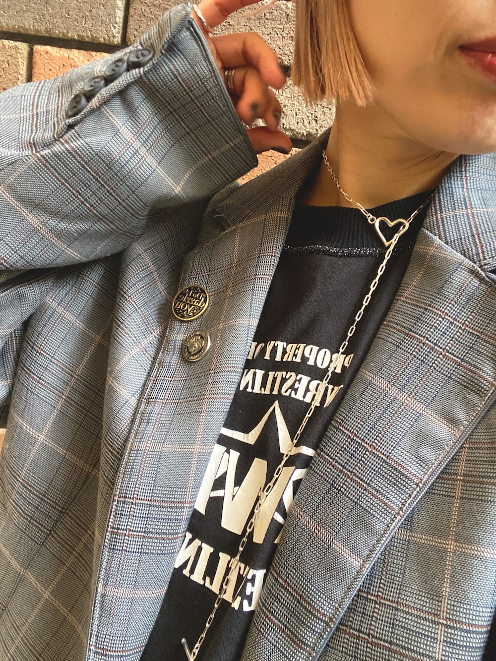 ブラック系のTシャツ/カットソー、グレー系のテーラードジャケット、ブラック系のスカートを着用したレディースの秋コーディネートの2枚目の写真