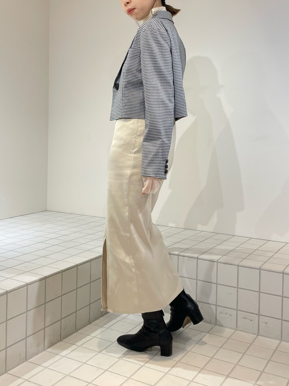 ブラック系のワンピース、ブラック系のテーラードジャケット、ホワイト系のTシャツ/カットソーを着用したレディースの冬コーディネートの4枚目の写真