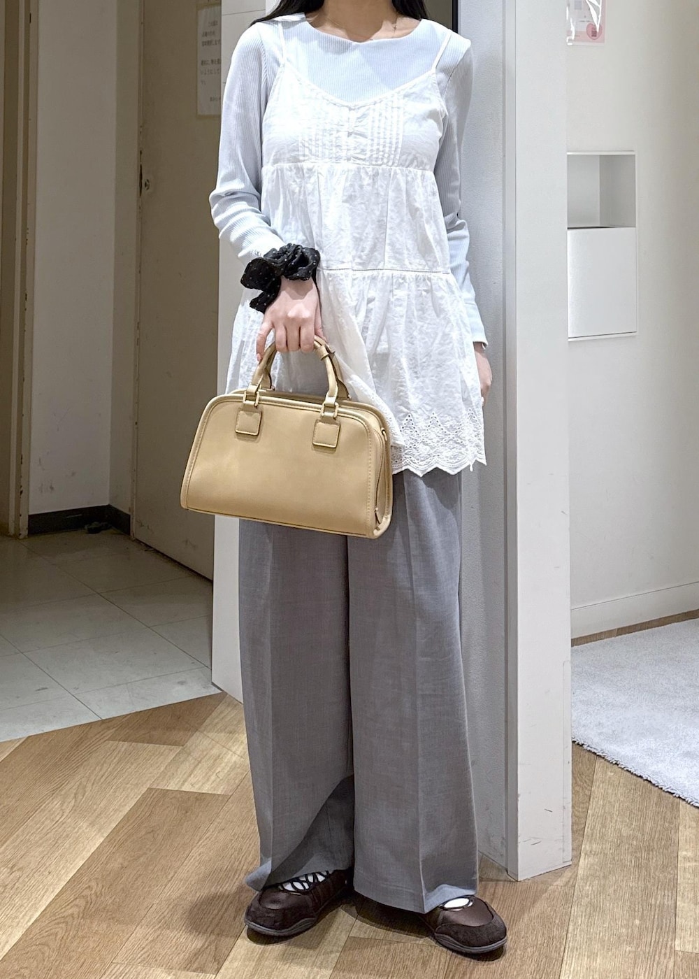 ベージュ系のボストンバッグ、ブルー系のTシャツ/カットソー、ホワイト系のキャミソールを着用したレディースの春コーディネートの10枚目の写真