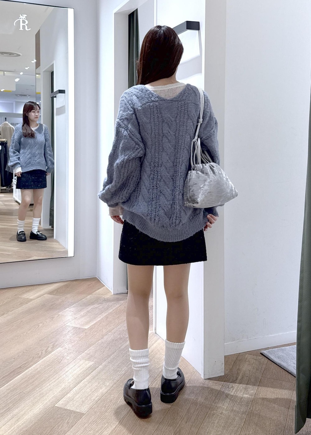 ブルー系のスカート、ホワイト系のTシャツ/カットソー、ブルー系のニット/セーターを着用したレディースの冬コーディネートの9枚目の写真