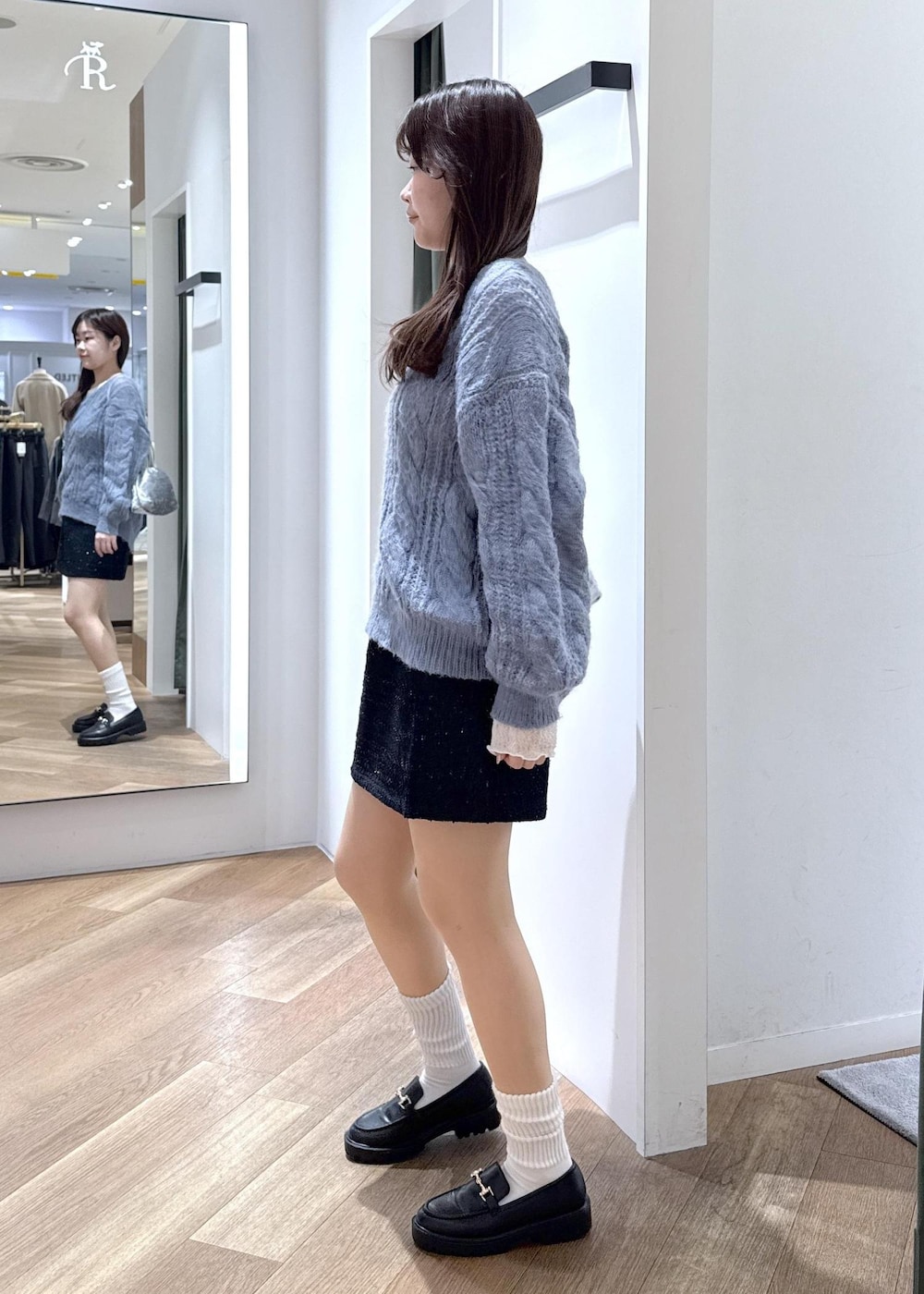 ブルー系のスカート、ホワイト系のTシャツ/カットソー、ブルー系のニット/セーターを着用したレディースの冬コーディネートの6枚目の写真