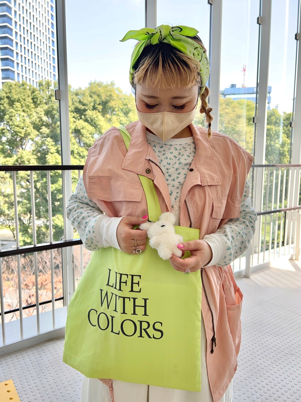 イエロー系のトートバッグ、ブルー系のTシャツ/カットソー、ホワイト系のワンピースを着用したレディースの春コーディネートの2枚目の写真