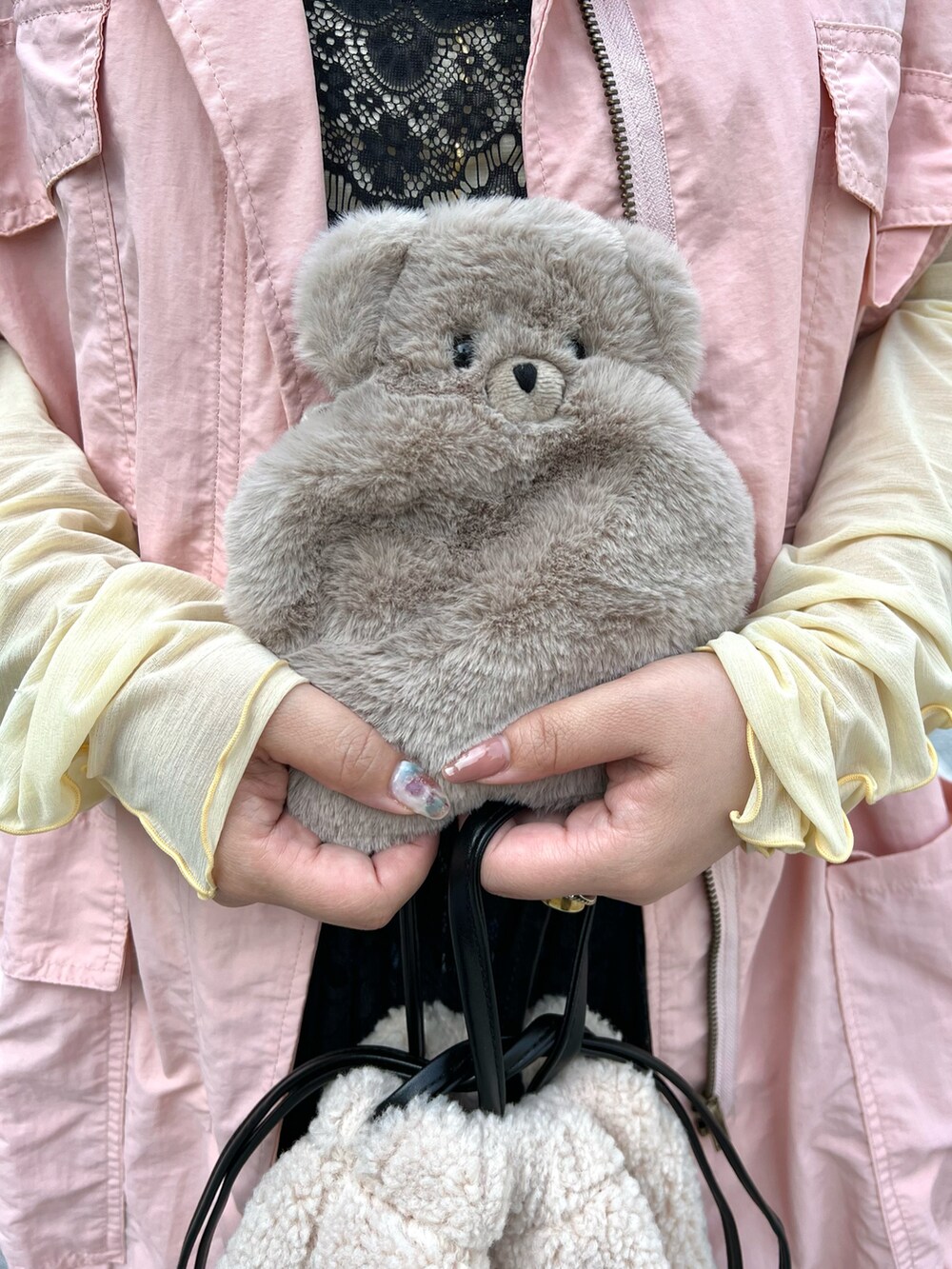 ホワイト系のショルダーバッグ、ピンク系のベスト、イエロー系のTシャツ/カットソーを着用したレディースの秋コーディネートの5枚目の写真