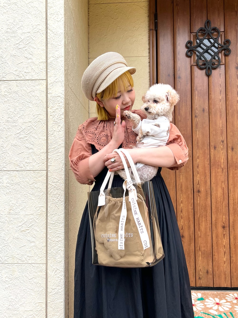 ホワイト系のトートバッグ、ブラック系のワンピース、ホワイト系のサンダルを着用したレディースの夏コーディネートの2枚目の写真