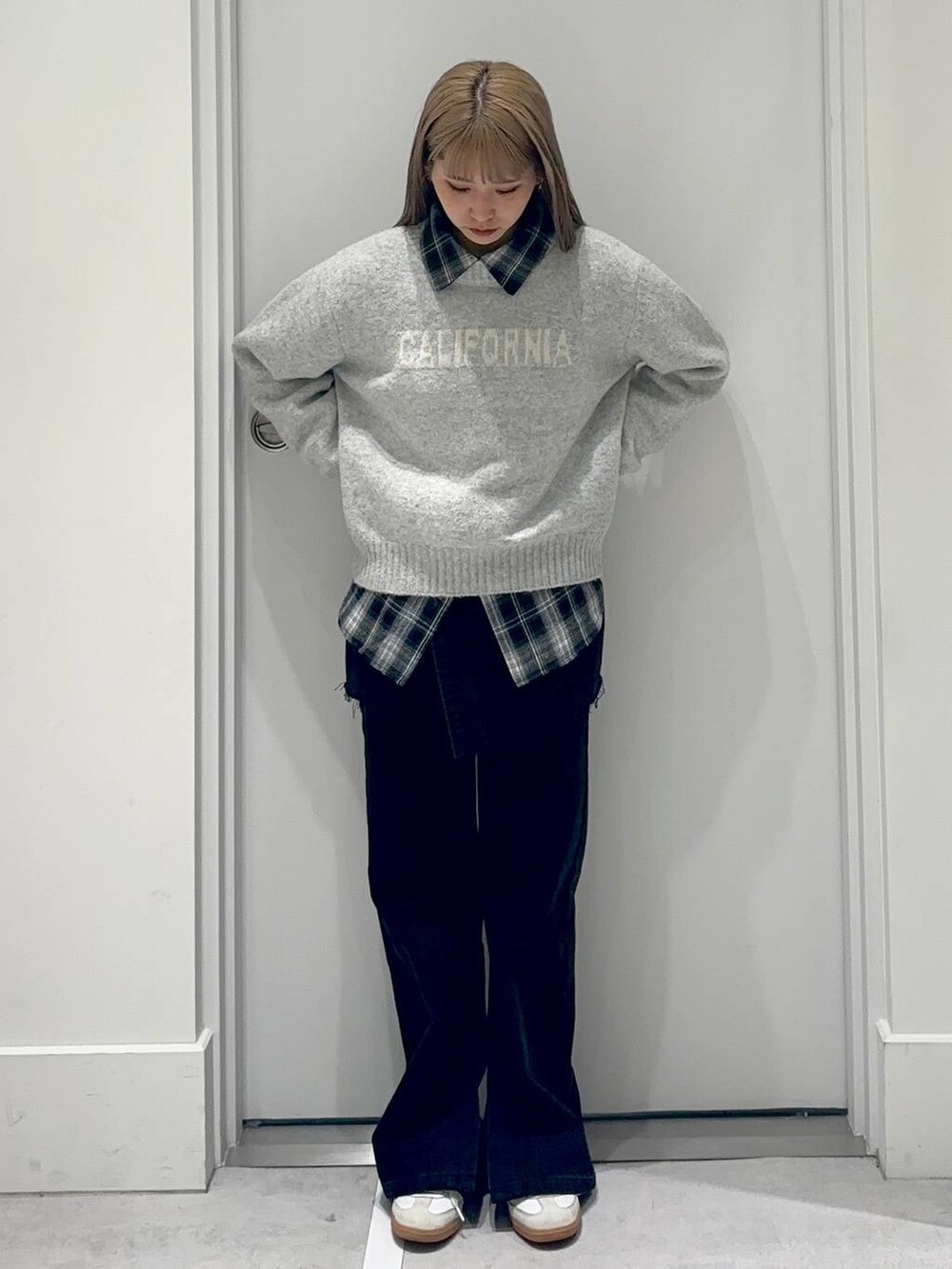 ブラック系のシャツ/ブラウス、グレー系のデニムパンツ、グレー系のニット/セーターを着用したレディースの冬コーディネートの2枚目の写真