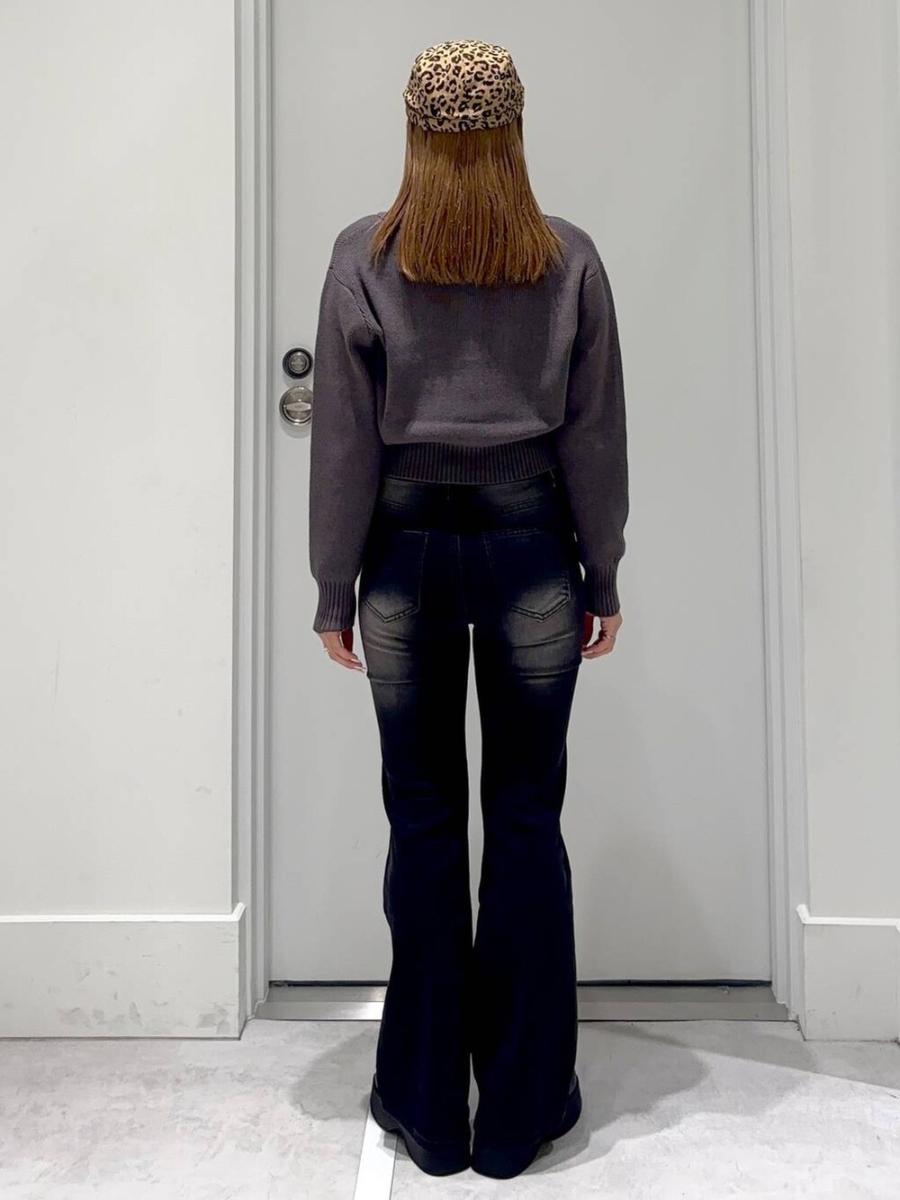 ブラック系のスリッポン、ブラック系のデニムパンツ、グレー系のカーディガン/ボレロを着用したレディースの冬コーディネートの4枚目の写真