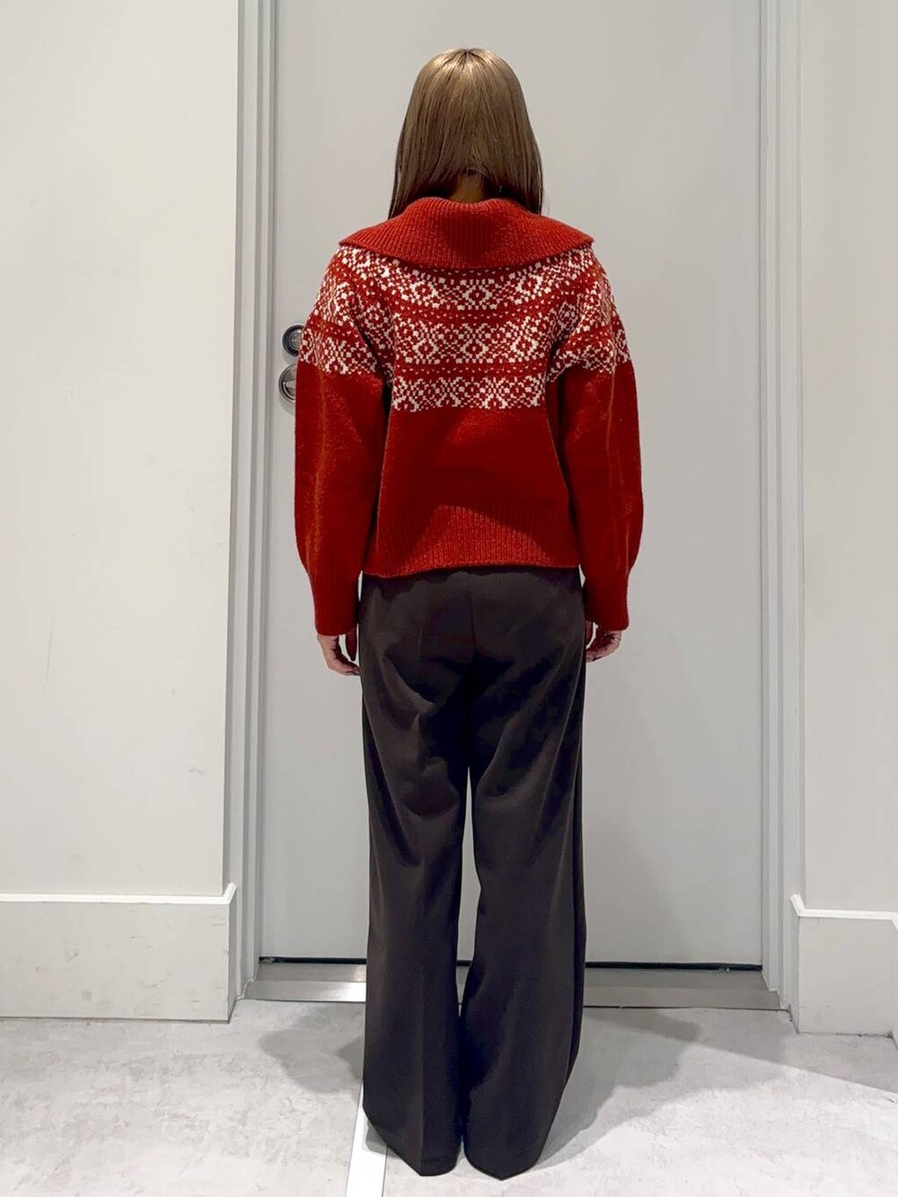 ブラウン系のスラックス、レッド系のニット/セーターを着用したレディースの冬コーディネートの4枚目の写真