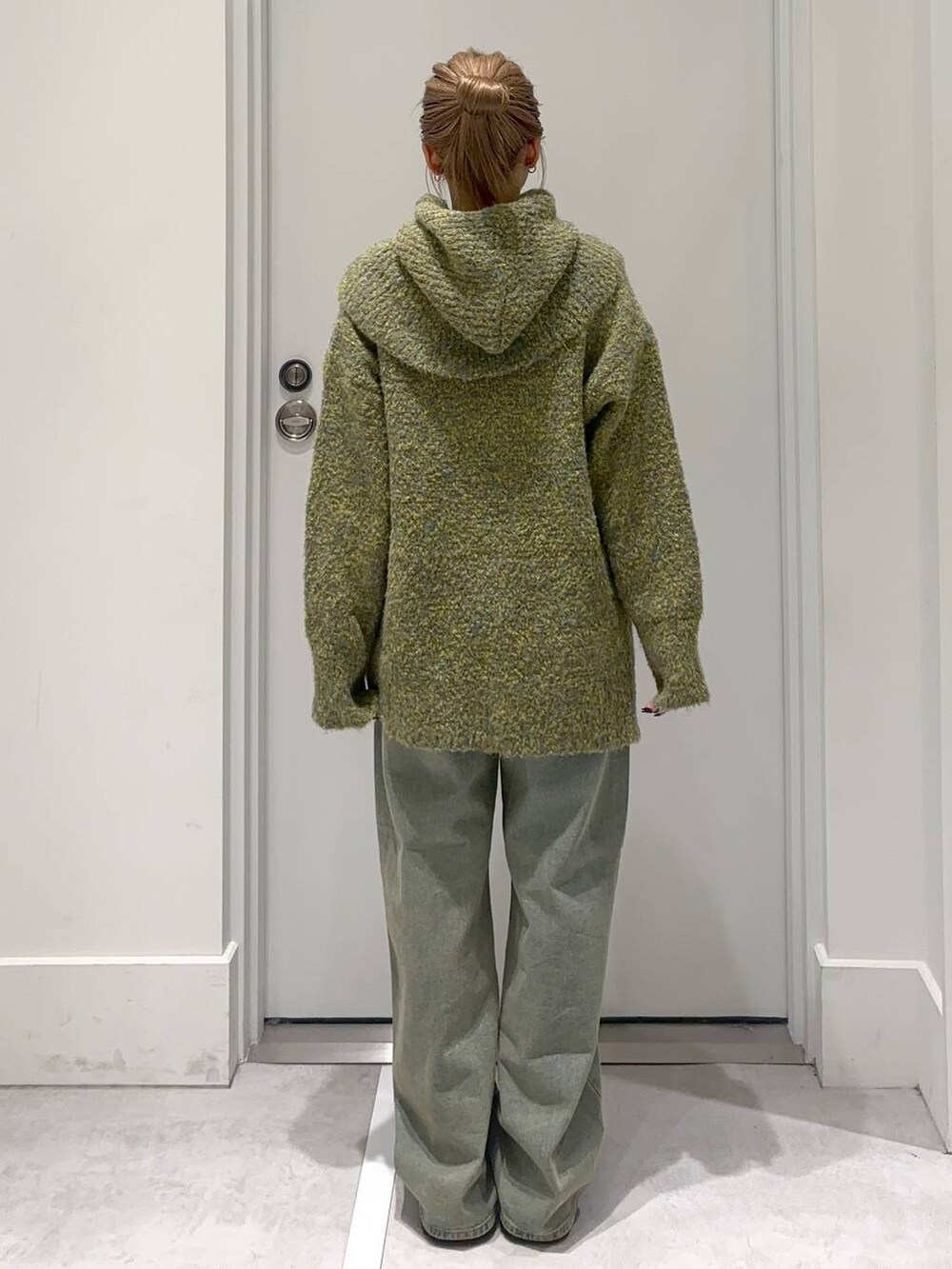 ブルー系のデニムパンツ、グリーン系のニット/セーターを着用したレディースの冬コーディネートの5枚目の写真