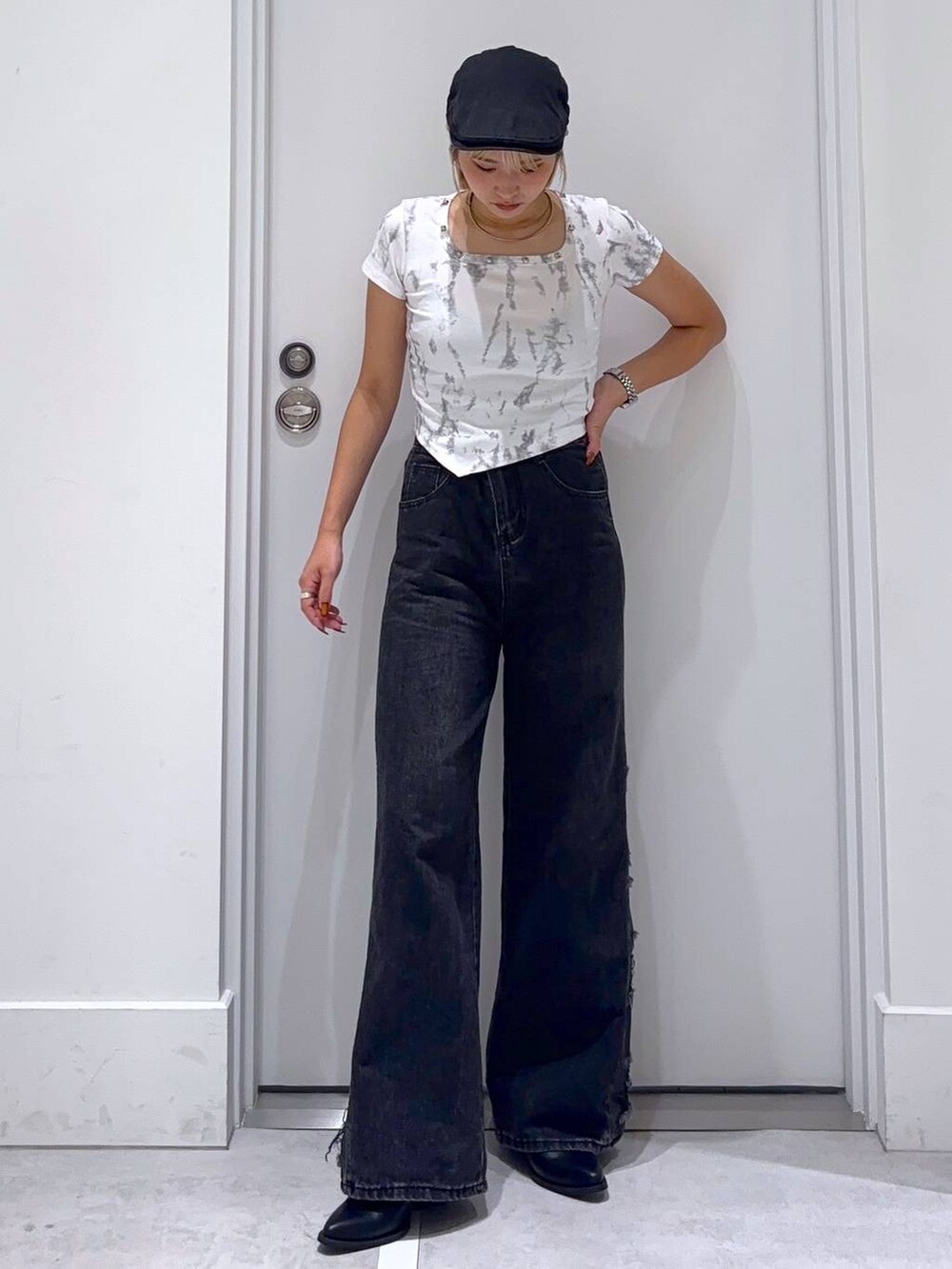 ブラック系のデニムパンツ、ホワイト系のTシャツ/カットソーを着用したレディースの秋コーディネートの2枚目の写真