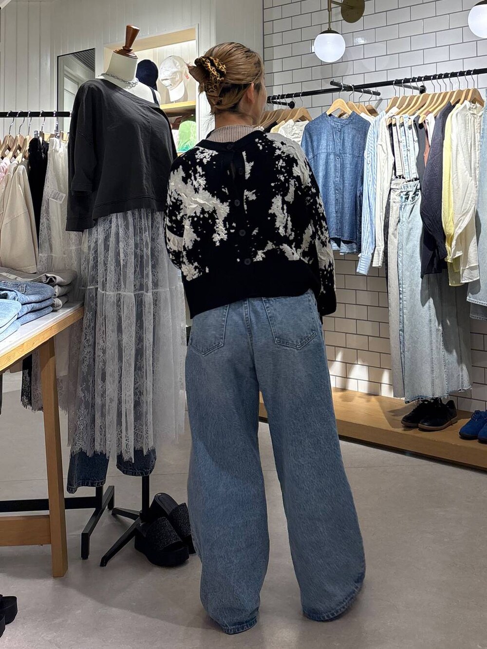 ブルー系のデニムパンツ、その他のスニーカー、ブラック系のカーディガン/ボレロを着用したレディースの春コーディネートの4枚目の写真