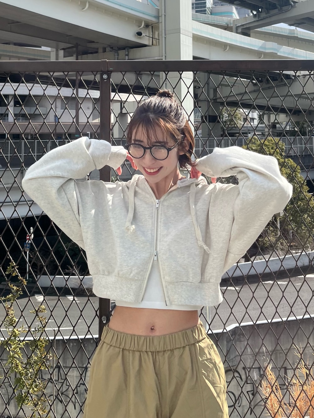 ホワイト系のパーカー、ベージュ系のその他パンツ、ブラック系のスニーカーを着用したレディースの春コーディネートの4枚目の写真