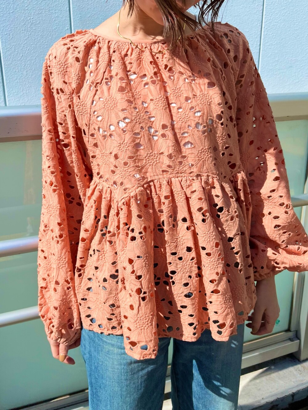 オレンジ系のシャツ/ブラウス、ブルー系のデニムパンツ、ゴールド系のパンプスを着用したレディースの冬コーディネートの3枚目の写真